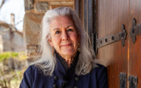 Gayle V. Economos leans on church door