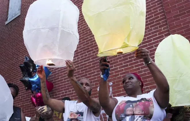 Two individuals releasing sky Lanterns